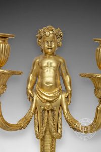 Paire d’appliques aux bustes d'enfants de style Louis XVI